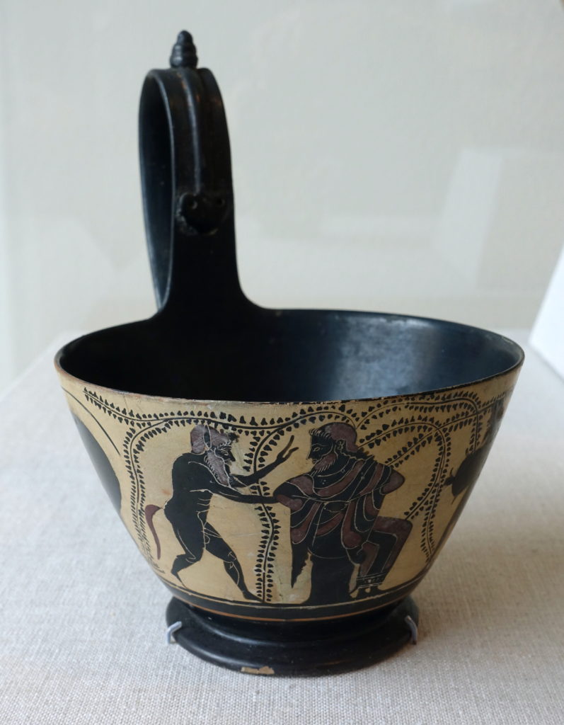 Dionysus_seated_between_two_satyrs,_kyathos_in_an_Etruscan_shape,_Greek-Attic,_c._510-485_BC,_black-figure_terracotta_-_Blanton_Museum_of_Art_-_Austin,_Texas_-_DSC07651